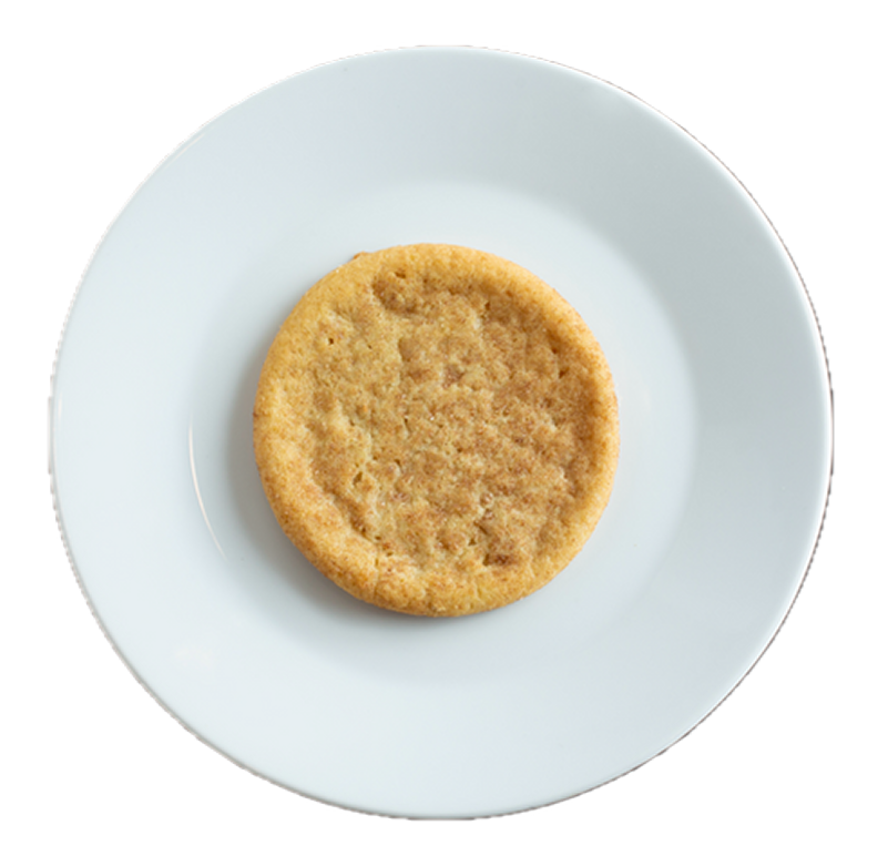 Golden brown cookie with textured surface on white ceramic plate against white background