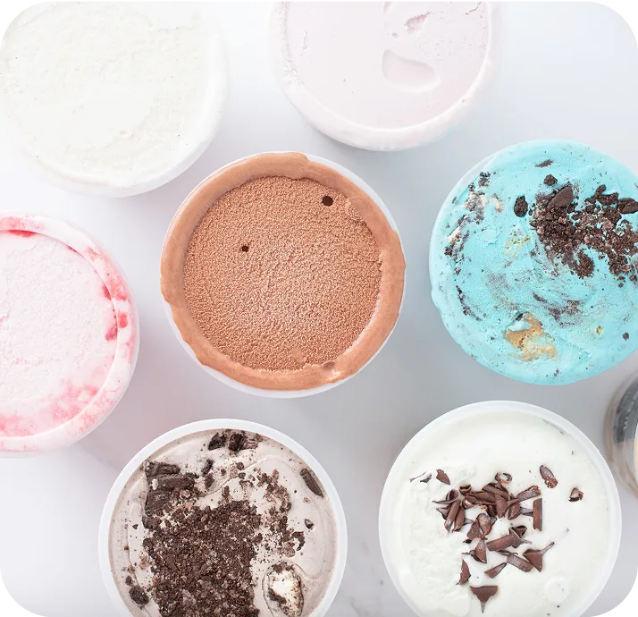 Six ice cream containers showing various flavors including chocolate, vanilla, strawberry, and mint chip with colorful toppings