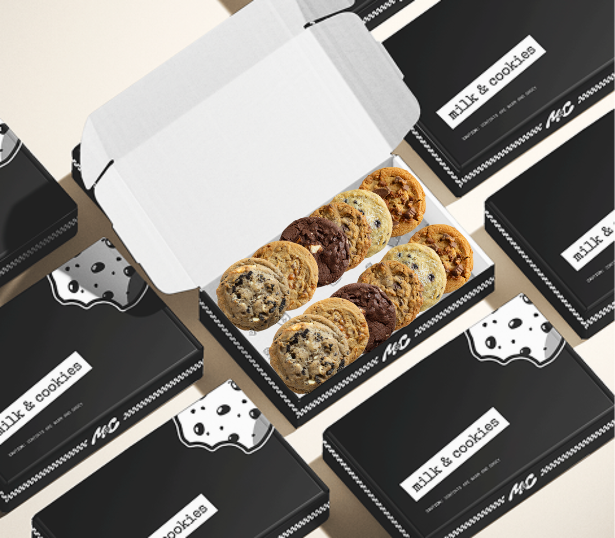 Assorted cookies in white box surrounded by black "milk & cookies" branded packages on beige background