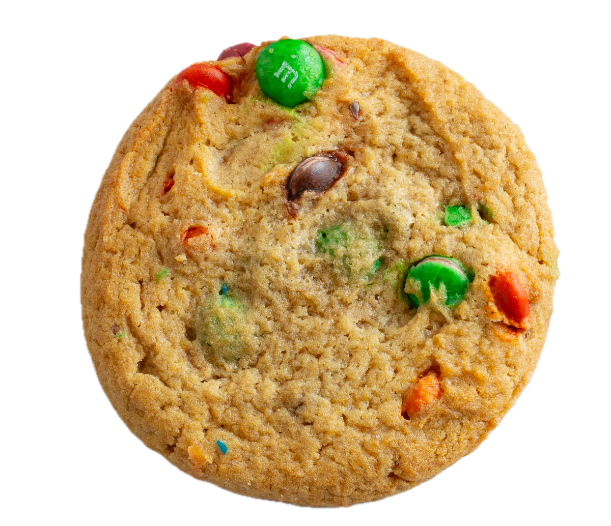 Golden brown cookie with colorful M&M candies - green, red, orange, and brown pieces embedded throughout the soft-baked surface