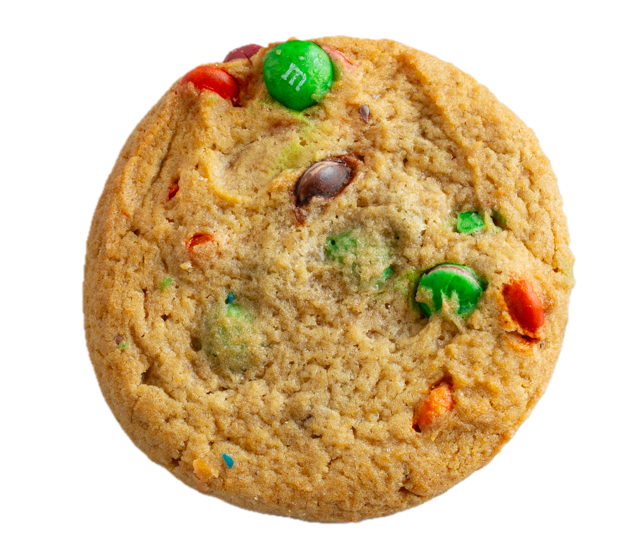 Golden brown cookie with colorful M&M candies in red, green, and brown scattered throughout the surface